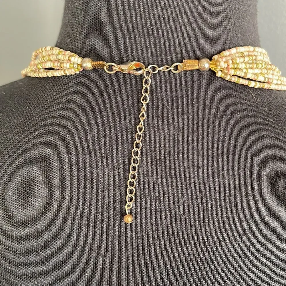 Multi strand bronze and pastel bead necklace.
